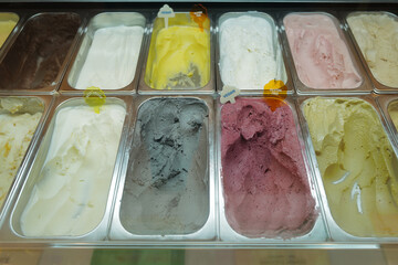 Display of assorted and colorful ice cream flavors in dessert store