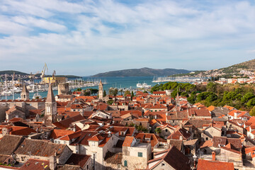 Fototapeta premium Picturesque aerial view from bell tower St Lawrence of historic coastal town Trogir, Split-Dalmatia, Croatia, Europe. Travel destination in summer. Cityscape dominated by cluster of red-tiled roofs