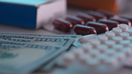 Money with medicines and pills. Economic aspects of healthcare.