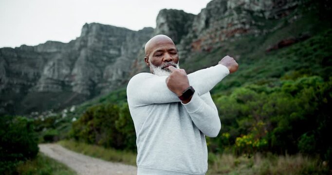 Mature, black man and mountain with stretching for fitness, workout or running in outdoor nature. Senior African, active male person or runner in warm up for trekking, hiking or exercise on path