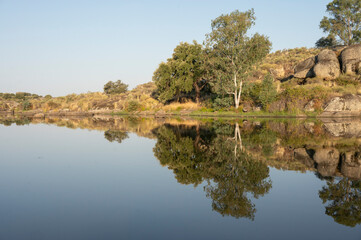 Aquatic Mirror: The calm water faithfully reflects the surrounding landscape.