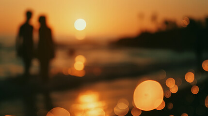 Two figures walk along a beach as the sun sets, casting a warm golden glow with playful bokeh effects.