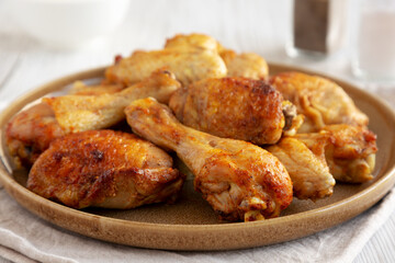 Homemade BBQ Chicken Drumsticks and Wings with Alabama White Sauce, side view.