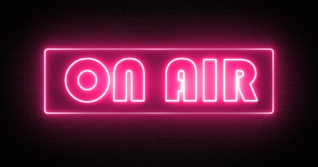 A neon light that glows pink to indicate that it is on air.