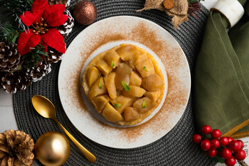 Delicious tarte tatin with apples from an overhead perspective. Food on a Christmas table.