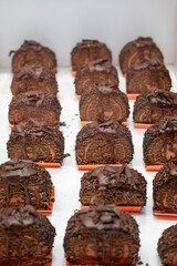 Detail of Small cakes or portions of roly-poly or jelly roll, sweets or artisanal cakes on the counter of a traditional pastry shop