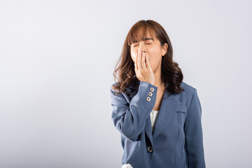 Portrait Asian beautiful young business woman emotions tired and sleepy her yawning covering mouth open by hand, studio shot isolated on white background, Female insomnia concept with copy space