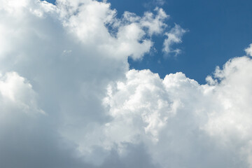 Clouds in a bright blue sky on a sunny day
