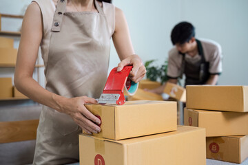 Small Business Owner Packing Boxes for Online Order in a Modern Workspace