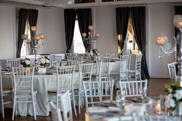 Elegant Wedding Reception Table Setting with Candles and Greenery at Evening Event