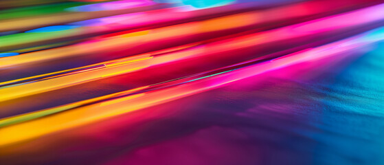 Vibrant, dynamic abstract photograph featuring colorful light streaks in shades of red, orange, pink, and blue on a smooth surface