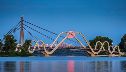 Pink Thunderstorm Full Moon rises on the background of pedestrian bridge in Obolon district, Kyiv, Ukraine 