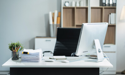 Workspace area with laptop tablet smartphone and paperwork on the table in the office concept.
