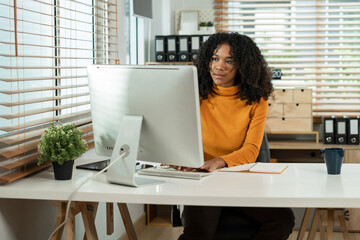 Businesswomen hand working with tablet and laptop computer with documents on office desk in modern office.