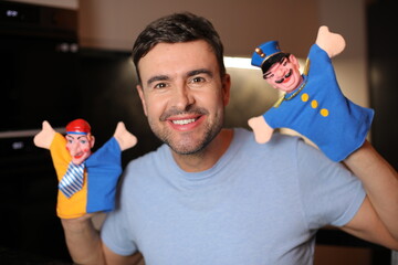 Guy holding some cute puppets 