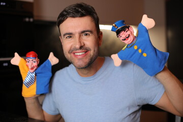 Guy holding some cute puppets 