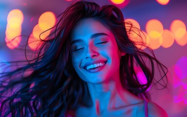 Obraz premium Attractive woman with long black hair, joyfully dancing and laughing in dark neon lights, minimalistic background