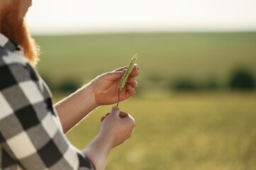 Man in white shirt is on the agricultural field