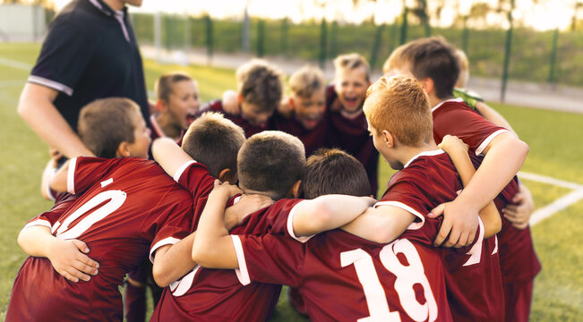 Team Sports for Kids. Children Sports Soccer Team. Coach Motivate Soccer Players to Play as a Team. Boys Kids Soccer Football Game. Young Children In Huddle Building Team Spirit.