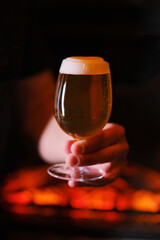 A glass of beer in a man's hand
