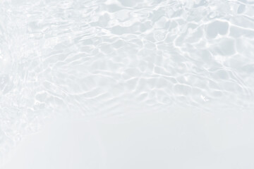 White water with ripples on the surface. Defocus blurred transparent white colored clear calm water surface texture with splashes and bubbles. Water waves with shining pattern texture background.