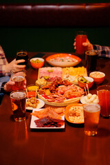 Glasses of beer and snacks on a table in a pub