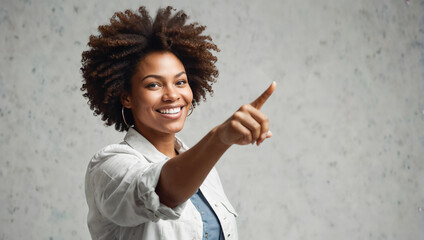 Confident Professional Woman with Afro Hair Smiling and Pointing