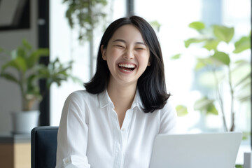 Chinese business woman happy working using laptop at office work place