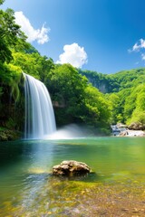 Fototapeta premium Scenic waterfall plunging into a calm pool in the wilderness