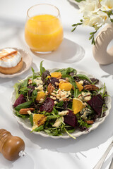 Delicious salad with baked beetroots and oranges on plate