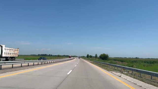 View from the driver's seat while driving on a highway. for themes related to travel, transportation, and road trips.