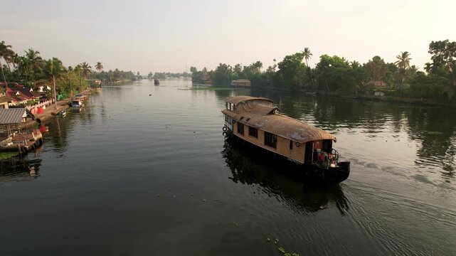 Houseboat Cruises Along Tranquil Canals In Alleppey, Kerala, Southern India. Aerial Drone view of houseboats in Alleppey. Travel, Vacation concept