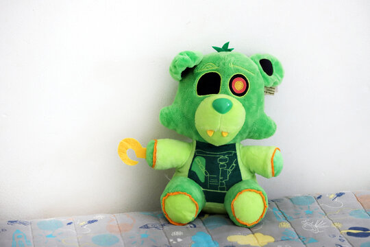 Radioactive Foxy plush, character from the series of video games, movies and books Five Nights Final Freddy. Green fox toy for children. Isolated white.