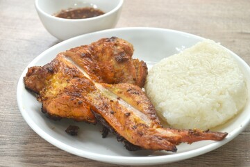 roasted chicken wing eat couple sticky riceon plate dipping with spicy sauce 