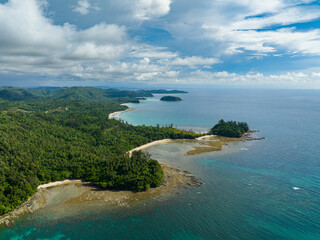 Aerial drone of Borneo island covered with rainforest and sandy beach. Borneo, Malaysia.