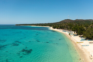 Fototapeta premium Beautiful beach, palm trees by turquoise water view from above. Pagudpud, Ilocos Norte, Philippines.