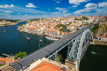 View of Porto city and Douro river with moored sailing ship and Dom Luis I bridge from famous tourist viewpoint Miradouro da Serra do Pilar on sunset. Porto, Vila Nova de Gaia, Portugal