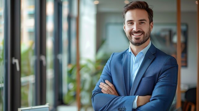 Portrait of a Handsome Smiling Businessman Standing with Arms Crossed in a Modern Office with Bright Light and Large Windows, Photorealistic Stock Photo