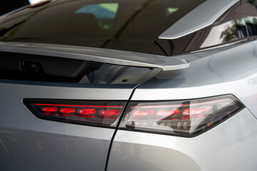 Fototapeta premium Close-up of the lights of a new energy electric car