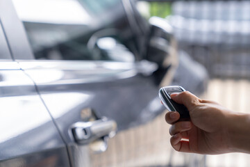 Hand unlocking car with car key