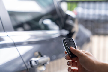 Hand unlocking car with car key