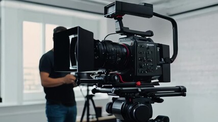 Videographer Filming with a Professional Camera on a Tripod