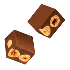 Chocolate explotion. Flying Cubes of milk chocolate bar with hazelnuts isolated on white background. .