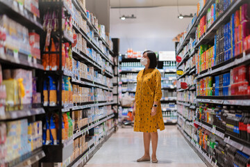 Portrait of a Woman shopping in the supermarket.