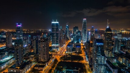 A stunning city skyline at night featuring illuminated skyscrapers against a dark sky.