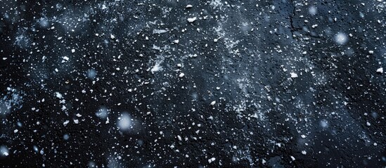 Obraz premium A wide photo featuring snow falling on asphalt from above with copy space image