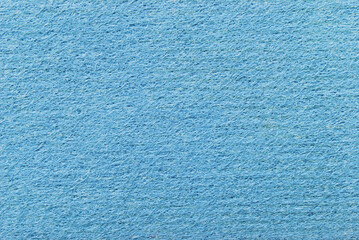 A sheet of porous, fibrous, and ribbed texture as background