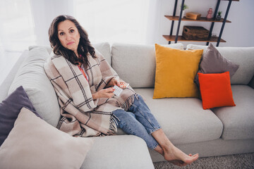 Photo of doubtful unsure lady wear plaid shirt drinking tablets indoors room home house