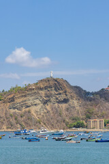 Obraz premium Beatuiful bay and beech of San Juan del Sur coastal town on the Pacific Ocean in southwest Nicaragua. Towering Christ statue in background.