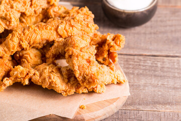 Crispy fried chicken breast strips with sauce